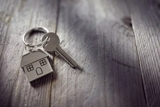 A key with a house key ring